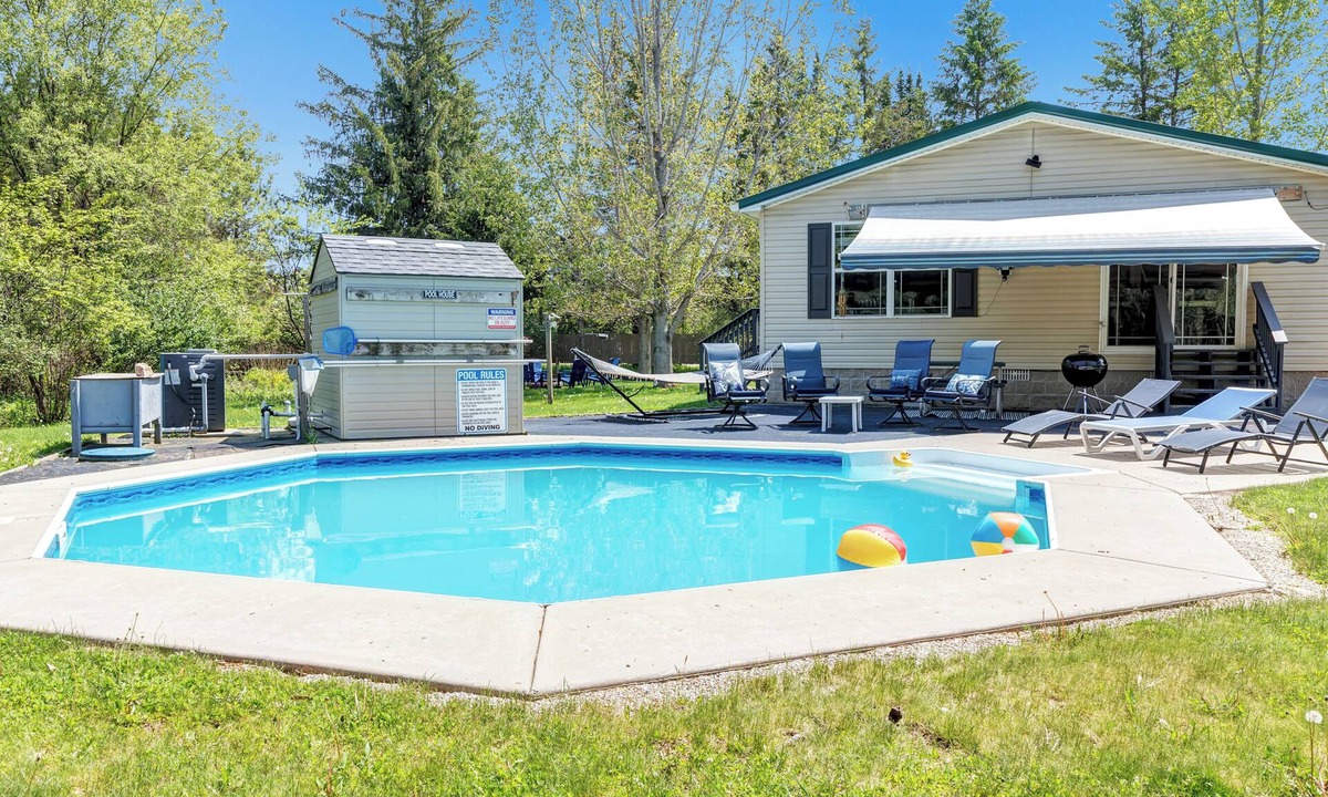Mountain House | Brand new listing! Relax and unwind at this stunning Northwoods pool house featuring a private in-ground pool, fire pit, patio, garage space, and sleeping for 11 guests!