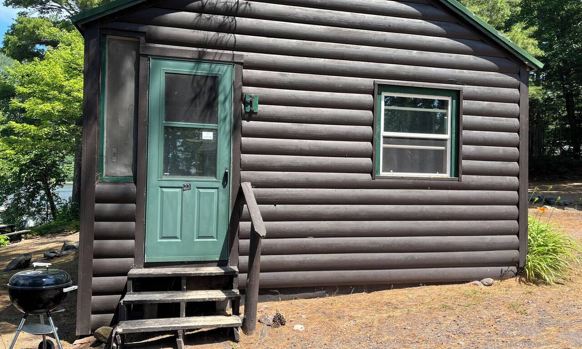 Lac La Belle Cabin | Charming Resort Cabin Steps from the Water and Campfire Evenings
