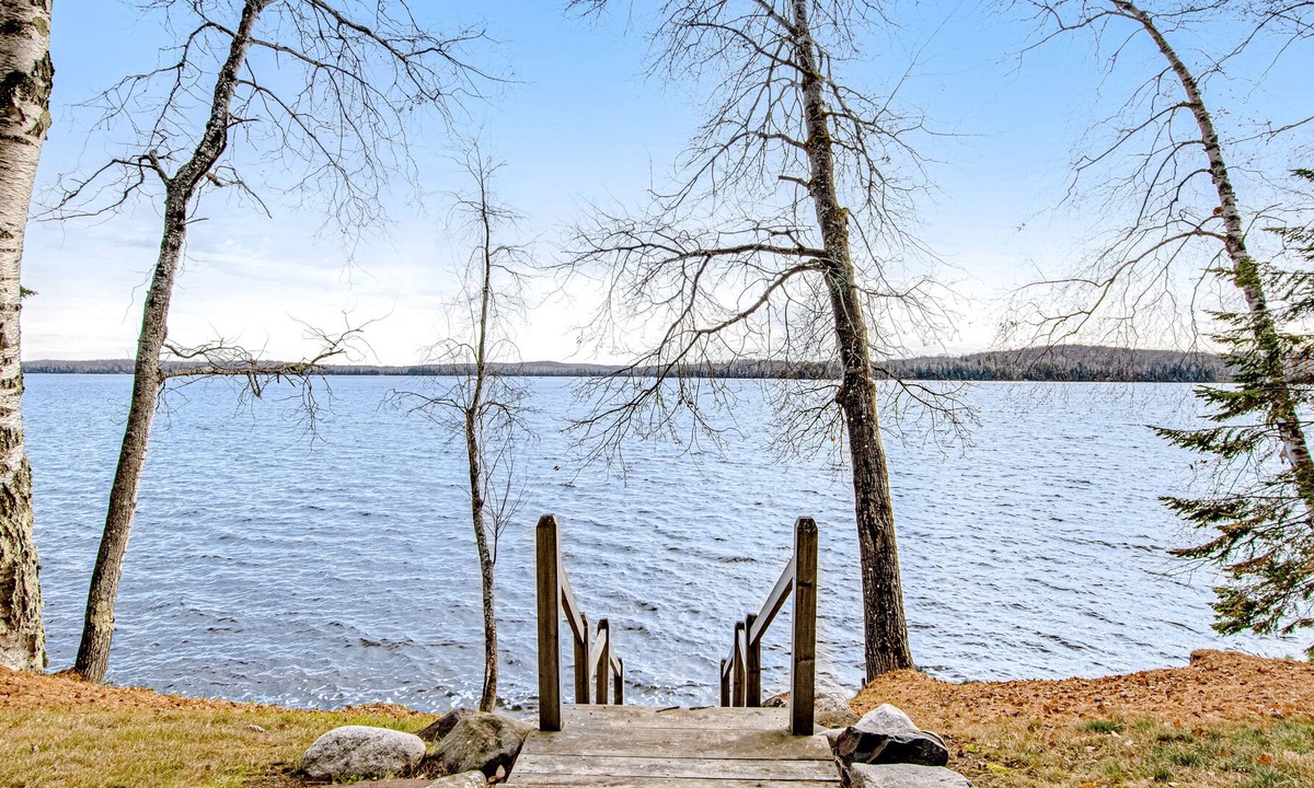 Presque Isle Cabin | Dog-friendly cabin with waterfront views, lake access, sandy beach, & rec room