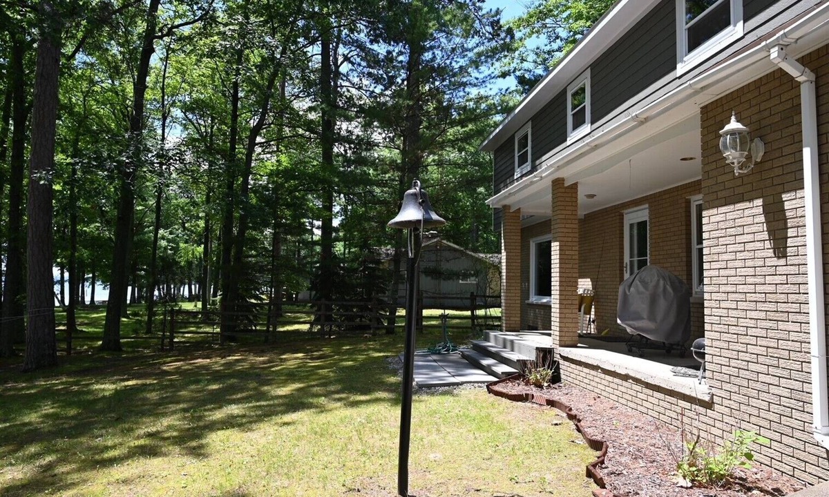 Hubbard Lake House | Spacious vacation home on large private wooded lot on crystal clear Hubbard Lake