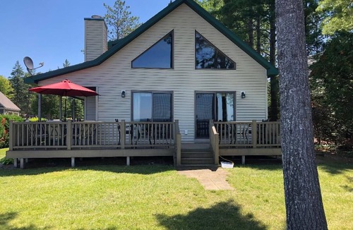 Onaway House | Black Lake sunset waterfront home 78' private sandy beach on prestine Black Lake