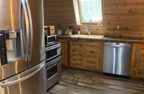 Paradise Cabin | Cozy Cabin nestled in the woods on all season road seconds from the trail system