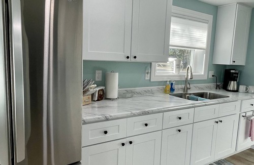 Oscoda Cottage | Cozy riverfront cottage with an easy beach-inspired coastal MI vibe!