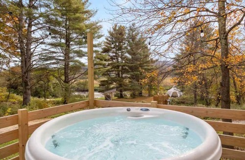 Johnson House | Designer A-Frame Treehouse with hot tub on river