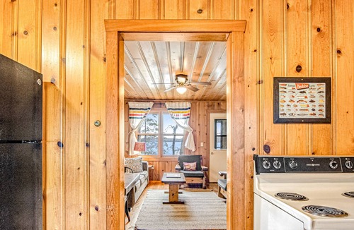 Presque Isle Cabin | Dog-friendly cabin with waterfront views, lake access, sandy beach, & rec room