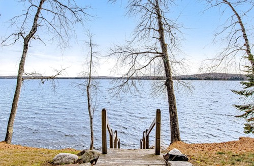 Presque Isle Cabin | Dog-friendly cabin with waterfront views, lake access, sandy beach, & rec room