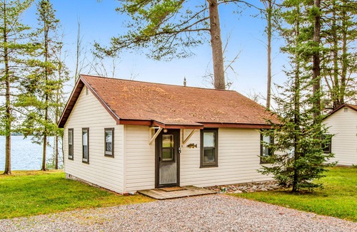 Presque Isle Cabin | Dog-friendly lakefront cabin with swimming, fishing, boating, & rec room