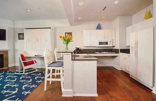 Bay Harbor Condo | Experience luxury at Captain Suite 219 in Bay Harbor, MI, featuring a cozy bedroom and village view.