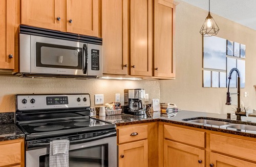 Three Lakes Condo | Lake-view condo with patio, fireplace, hot tubs, pools, firepit, gym, golf & W/D