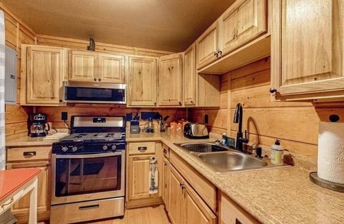 Three Lakes House | Lakeside cabin with a firepit, sunroom, & seasonal dock