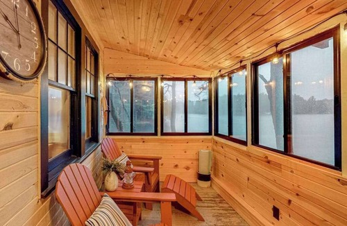 Three Lakes House | Lakeside cabin with a firepit, sunroom, & seasonal dock