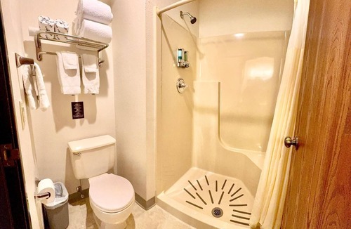 Boulder Junction Apartment | One queen bed, private bathroom, two-person whirlpool tub, mini fridge, and single-serve coffee maker.