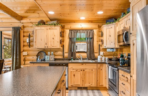 Lyndon Station Cabin | Riverfront cabin with a dock, kayaks and a canoe - firepit and water views