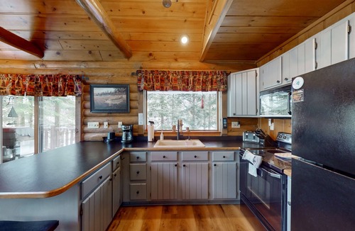 Presque Isle Cabin | Spacious and beautiful lakefront log home on 7 acres with private dock