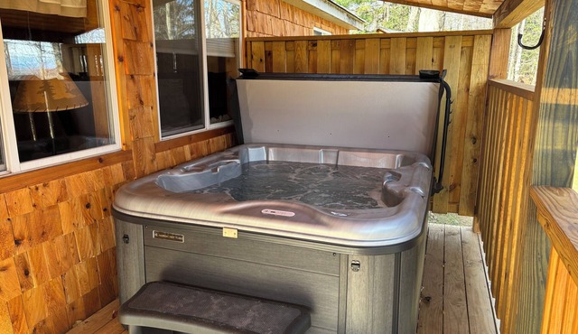 2 bedroom cabin on beautiful lakefront property with an outdoor hot tub