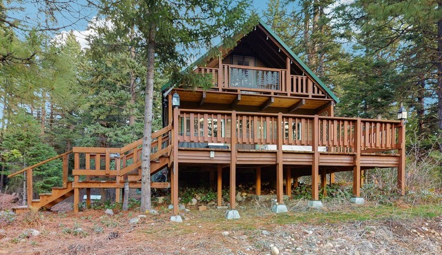 Charming lakefront cabin with hot tub, private beach, and mountain views