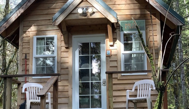 Experience a custom built tiny home cabin near Mt Rainier National Park. It sleeps up to three! Firepit, access to shared hot tub, walking distance to Copper Creek Restaurant