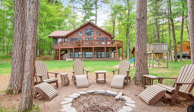 Lakefront dog-friendly home with firepit, play set, dock, & beach access