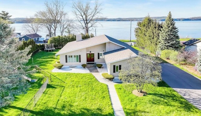 Lakefront home with pool, beach access, central AC, washer/dryer, & fireplace