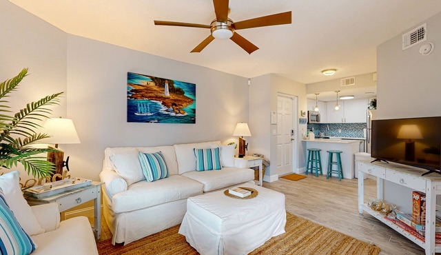 Pristine condo with shared pool, hot tub, and balcony with partial ocean view