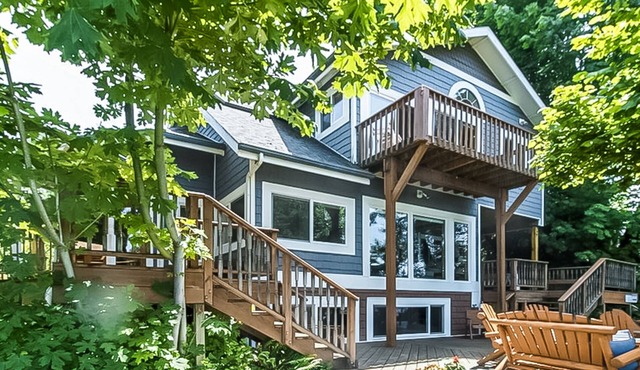 Stunning riverfront home w/ spacious deck, grill, two kitchens, & private dock